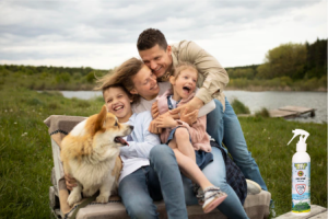 A very happy family spending time together outdoors with their doggie too. Minus Bite bug spray is a must have for these moments