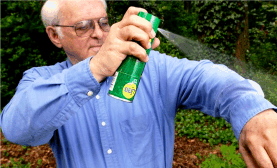 A man spraying deet onto himself. Breathe Easy: How Using Natural Bug Spray Can Help Prevent Respiratory Problems